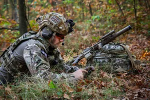 Soldier with Warrior Assault Systems gear reading a map